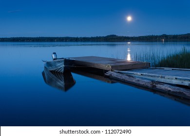 Boat Dock At A Moon-lit Lake