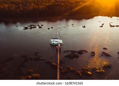 Boat at the Dock on a River at Sunset
