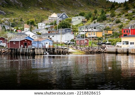 Boat dock scene at a small Atlantic Canada fishing village in Petty Harbour Newfoundland.