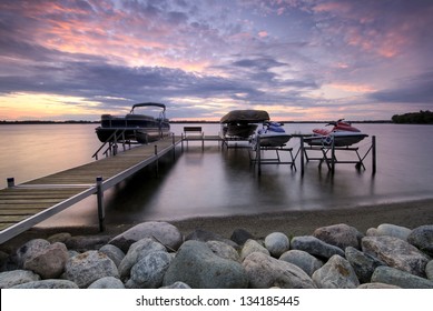 Boat Dock At Sunset With Raised Boats And Jet Ski's