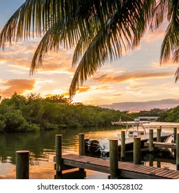 Boat Docked At Guanabanas Restaurant During Gold Sunset In Jupiter Florida