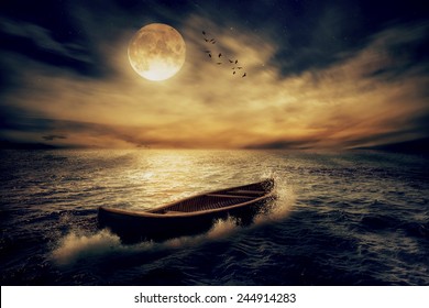 Boat drifting away in middle ocean after storm without course moonlight sky night skyline clouds background. Nature landscape screen saver. Life hope concept. Elements of this image furnished by NASA - Powered by Shutterstock