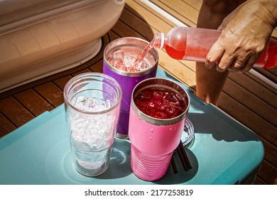 Boat Drinks Poured From A Bottle Into Insulated Glasses With Ice Sitting On An Ice Chest On A Luxury Boat.