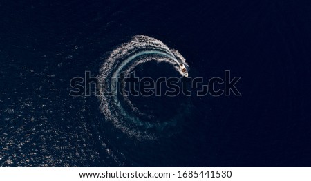 Similar – Aerial view of small boat in sea