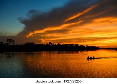 A Boat During Sunset On The Guaporé-Itenez River, Guaporé River Indigenous Land, Rondônia State, Brazil - Bolivia Border