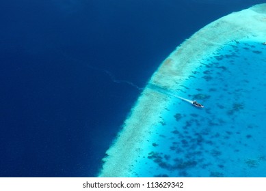 boat enters lagoon from deep blue ocean
