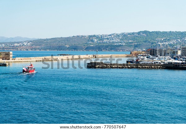 the boat enters the port of the\
city. The island of Crete. The city of Chania at Sunny\
day.
