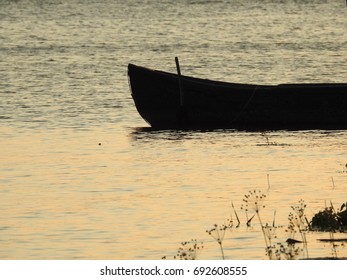 Boat floating at sunset
