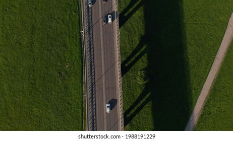 Boat Floats On River Under Bridge