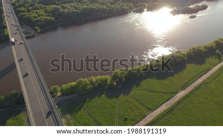 Boat Floats On River Under Bridge