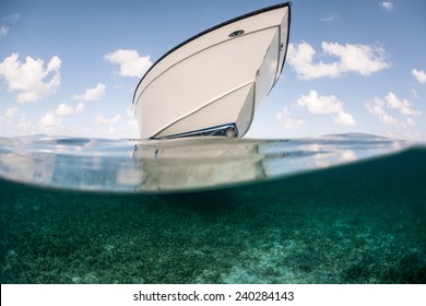 A boat floats in shallow water in the Caribbean Sea. This tropical region is a popular vacation destination for kayakers, divers, snorkelers, and recreational fishermen.