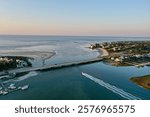 A boat going through a small bridge in Isle of Palms, SC catching the sunrise