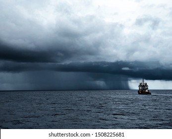 Boat Heading Into Squall In The Ocean