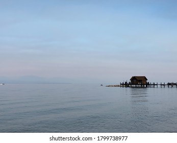 Boat House And Dock Along Lake Tahoe And Smokey Skies Over Lake Tahoe Basin