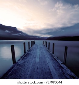 Boat Jetty And A Calm Lake At Sunrise, New Zealand.