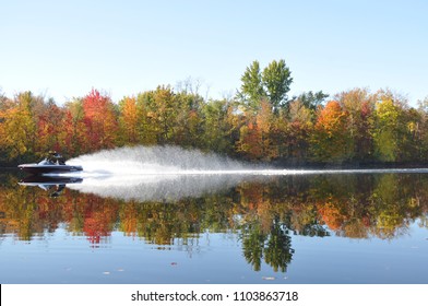 A Boat Makes Waves As It Speeds Across The Hudson River In Fall