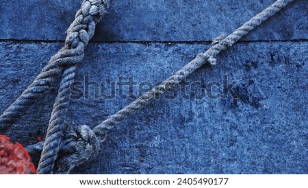 boat mooring ropes from the port on the cement
