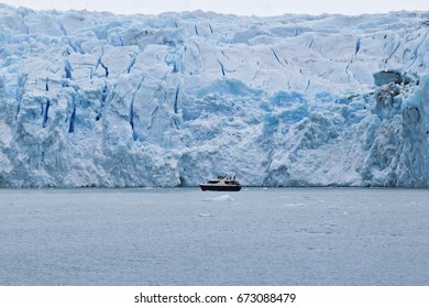 Boat Near Upsala Glacier Wall In Patagonia Lake