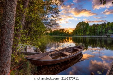 Boat next to a calm lake with beautiful sunset in Sweden. Great colors. - Shutterstock ID 2166370711