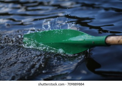 Boat Oar In The Water And Splashing Water