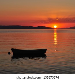 Boat on the adriatic sea at amazing sunset. Podgora, Croatia
