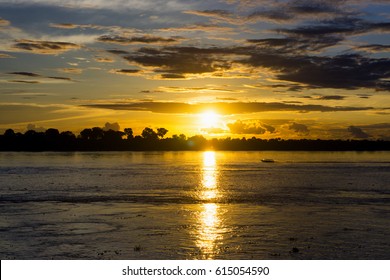 Boat On The Amazon River At Sunset Near Leticia, Colombia