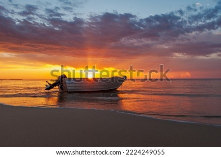 Boat on the beach at sunset. Eighty Mile Beach, Western Australia.