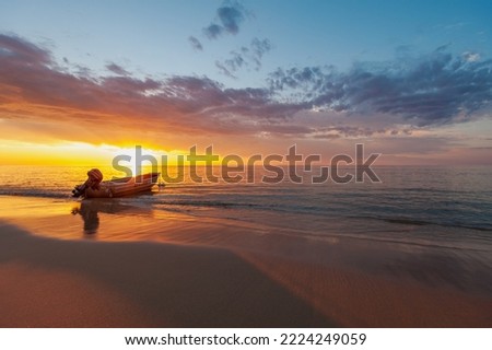 Boat on the beach at sunset. Eighty Mile Beach, Western Australia.