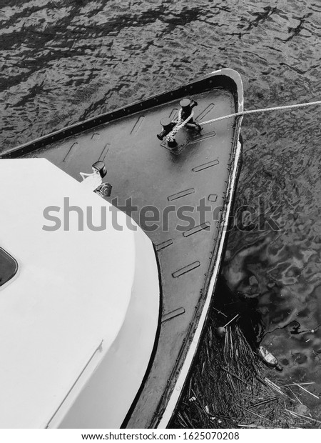 Boat on the river. Trash and the environment.\
Monochrome photography