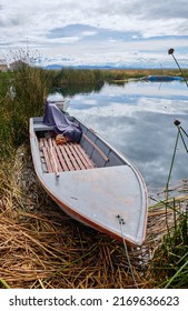 Boat on the shores of a floating island on Lake Titicaca in Uros, Peru.