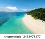 Boat over clear water in Puka Shell Beach with white sand. Boracay Island. Philippines.