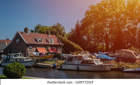 Boat Parked Beside The House,Travel Documentary Of Everyday Life And Place. Classic Motorboat Moored By A Pier Outside A House.