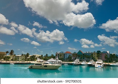 Boat Pier  In Bahamas Nassau Island. Colorful Houses In Waterfront With Blue Skyline