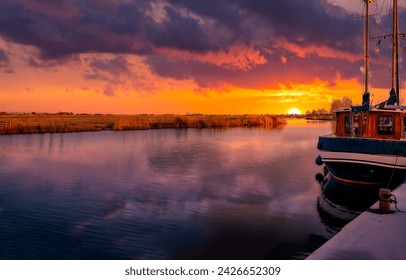 Boat at the pier at dawn. Pier at dawn. Beautiful sunrise over pier. Boat at dawn