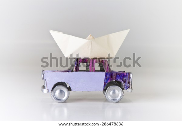 The boat is ready on the car: it\'s time to leave\
for the holidays by the sea