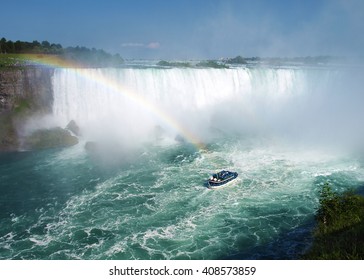 Boat ride and rainbow in Niagara Falls, New York with bright turquoise water