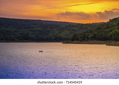 boat riding under sunset sky - Powered by Shutterstock