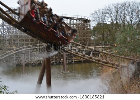 Boat rushing down a rollercoaster track in a theme park