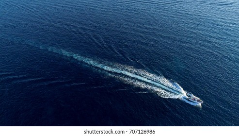 Boat at sea leaving a wake