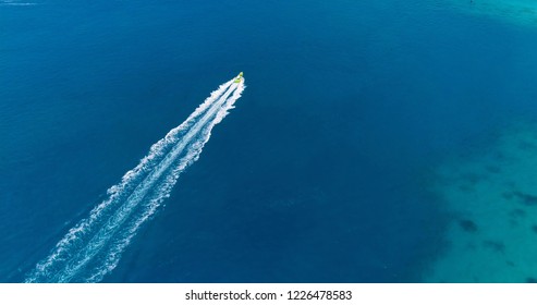 Boat at sea leaving a wake, aerial view