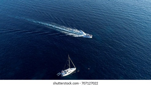 Boat At Sea Leaving A Wake And Sailboat