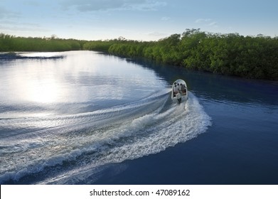 Boat ship wake prop wash curve on sunset lake river
