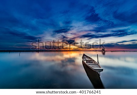 The boat speeding toward the sun as if to hold back the light at sunset like A arrow shooting in the sky sunset. This picture was taken in Pha Tam Giang Lagoon, famous lagoon in Hue, Viet Nam ,Travel
