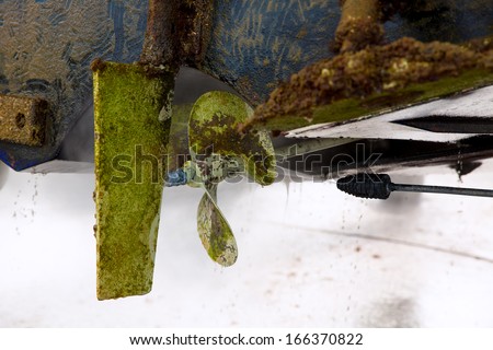 Boat stern hull and propeller pressure water cleaning on beached ship