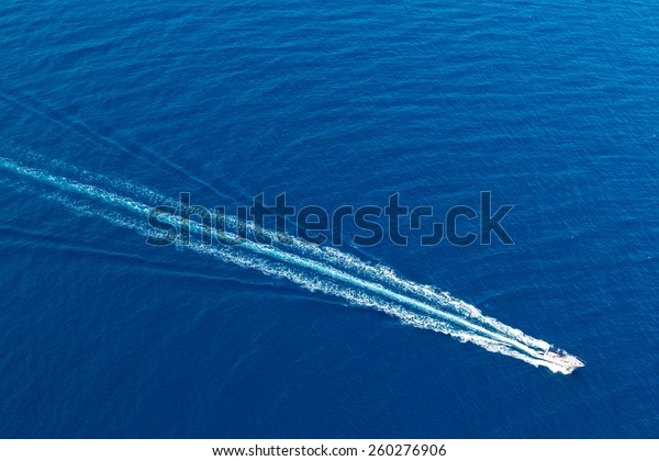 Boat surf foam aerial from prop wash in blue Majorca\
mediterranean sea