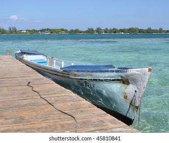 Boat Tied To Pier; Utila, Bay Islands, Honduras