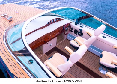 Boat Top View. Travel On A Pleasure Boats. Fragment Of A Speed Boat. Sale Of Passenger Boats. Place For The Control Of The Boat. Facing With A Tree. Steering Wheel. Wooden Deck. Concept - Luxury. 