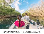 Boat tour in the Everglades, Florida, USA. Popular tourist attraction from the Keys, Miami ,Orlando. People on guided ride for wildife sighthing of alligators, wetlands.
