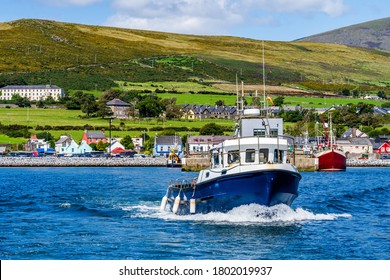 Boat tour leaving Dingle harbour for sightseeing and Fungie Dolphin watching with Dingle village in background. Co Kerry, Ireland - Shutterstock ID 1802019937