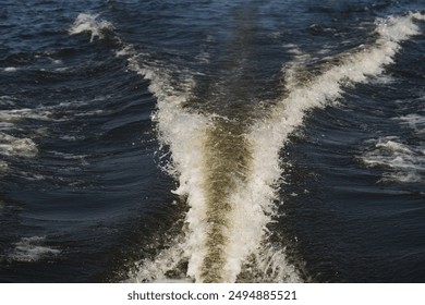 boat trail on river surface on a sunny day - Powered by Shutterstock